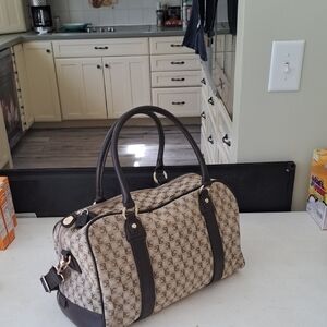 Tan and Brown Duffel Bag with Cylindrical Shape and Leather Handles